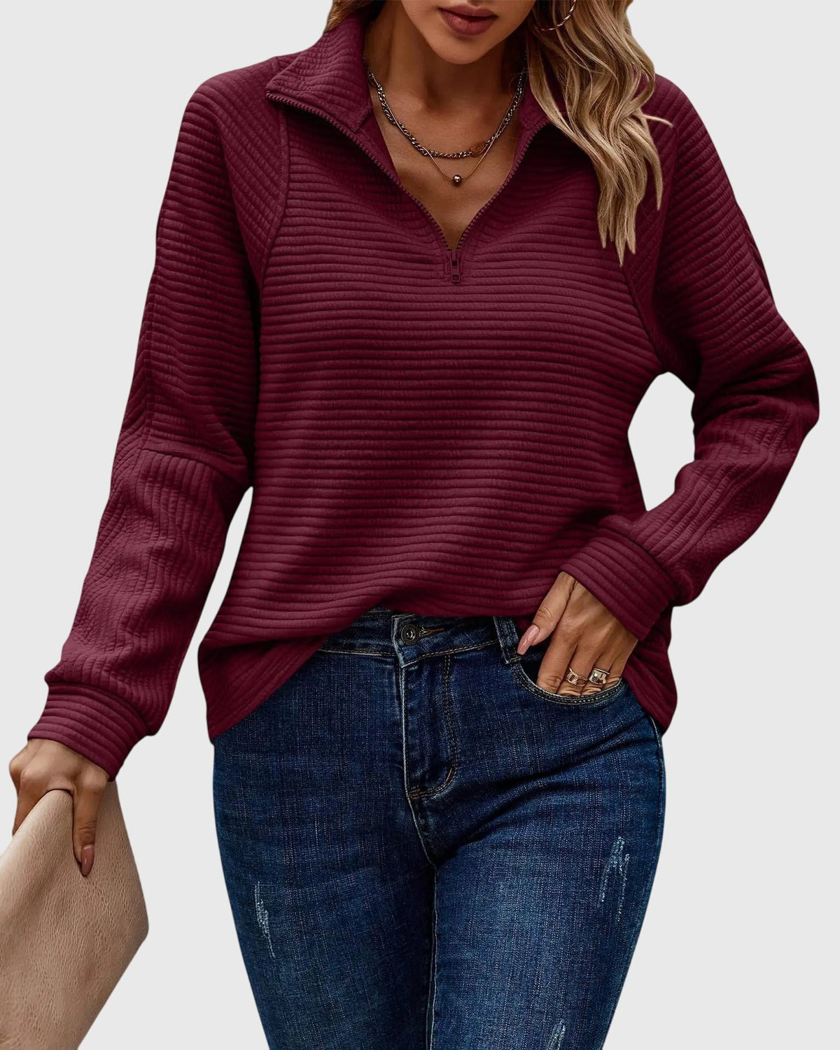 Women’s maroon ribbed knit quarter-zip jumper with long sleeves and knit collar.