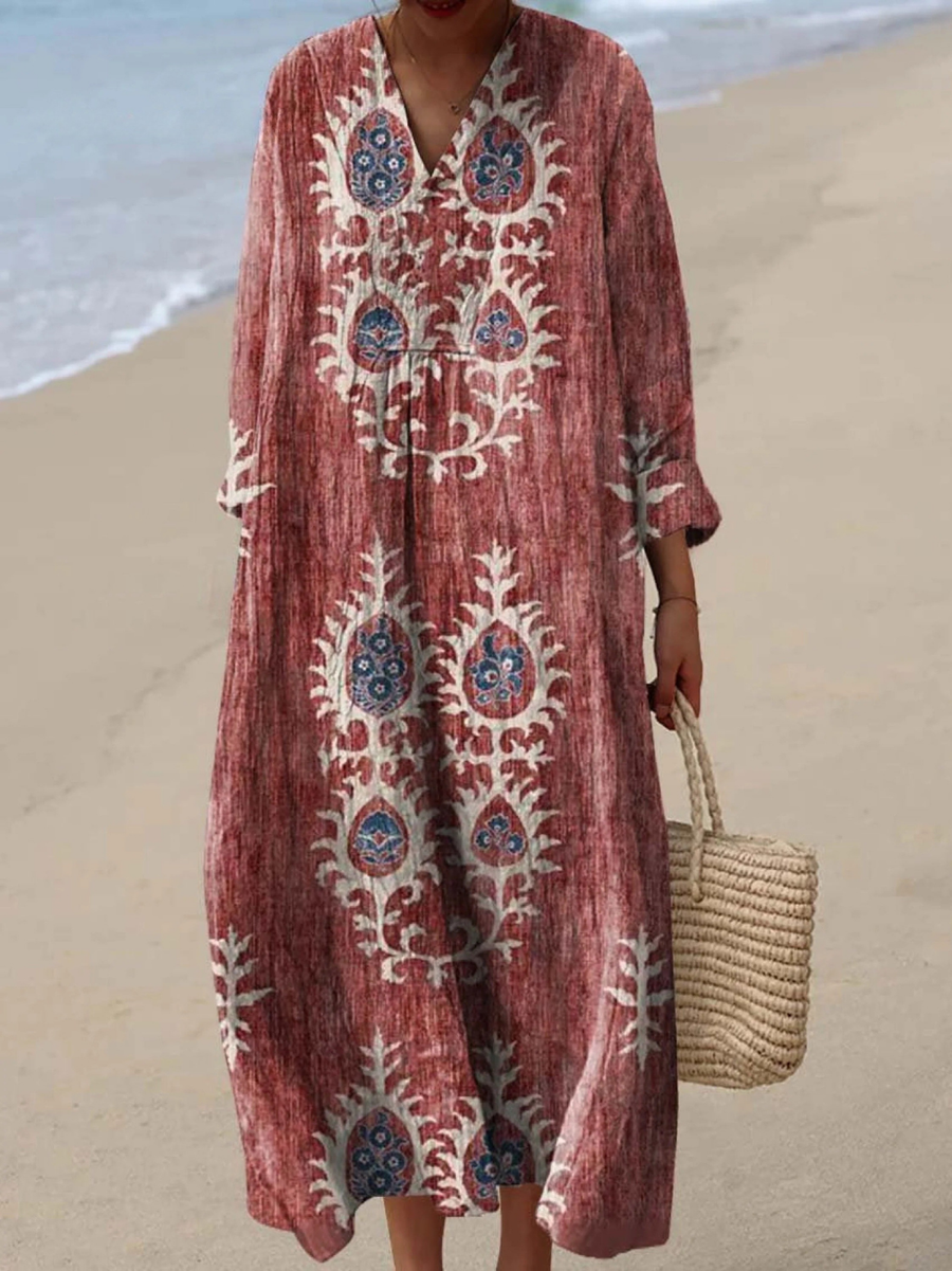 Rust red boho maxi dress with white folk embroidery, V-neck, long sleeves, loose drape.