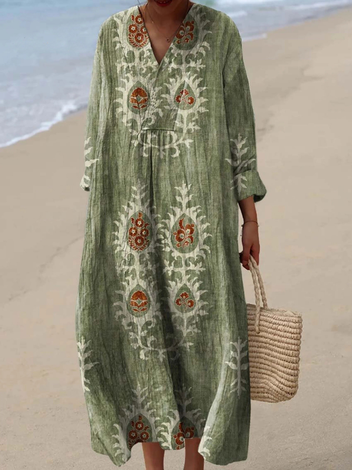 Green boho maxi dress with embroidered folk motifs, V-neck, long sleeves, relaxed fit.