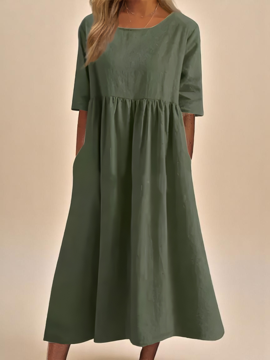 Abito classico verde con maniche corte e vita arricciata, gonna svasata