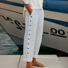 Blue-and-white striped trousers with front button placket and tapered legs