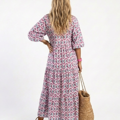 Tiered midi dress back view with geometric lilac-teal pattern and 3/4 puff sleeves
