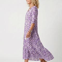 Purple printed midi dress with V-neck and tassel tie, side view, flared skirt