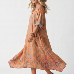 Orange printed midi dress with notch neckline, oversized fit, and side pockets