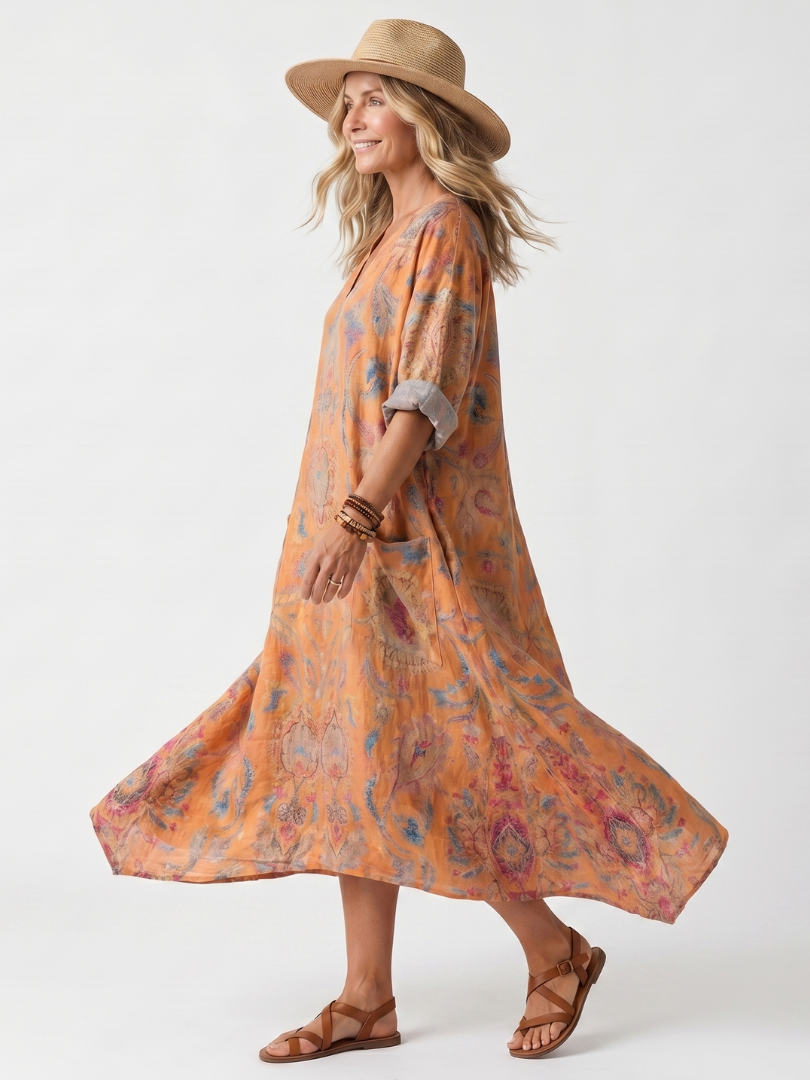 Orange printed midi dress with notch neckline, oversized fit, and side pockets