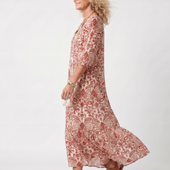 Red ornate print midi dress with flared skirt and three-quarter sleeves, side view