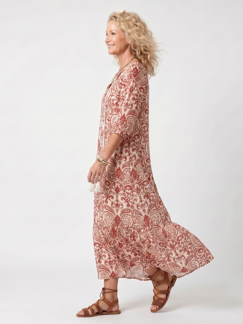 Red ornate print midi dress with flared skirt and three-quarter sleeves, side view