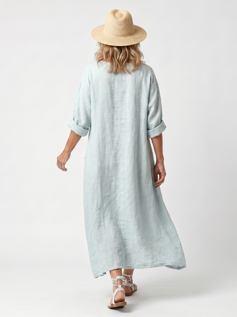 Sky blue pocket midi dress, back view, three-quarter sleeves and midi hem