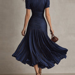 Dark blue striped satin midi dress from back, fitted waist and flared pleated skirt.