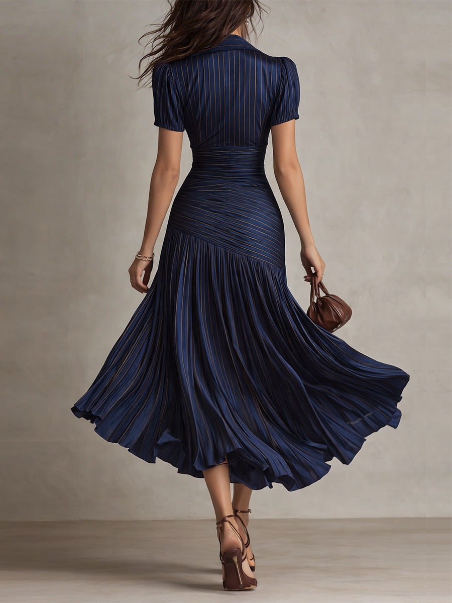 Dark blue striped satin midi dress from back, fitted waist and flared pleated skirt.