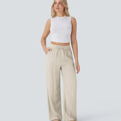 Beige wide-leg trousers with elastic waistband and drawstring ties, full length view