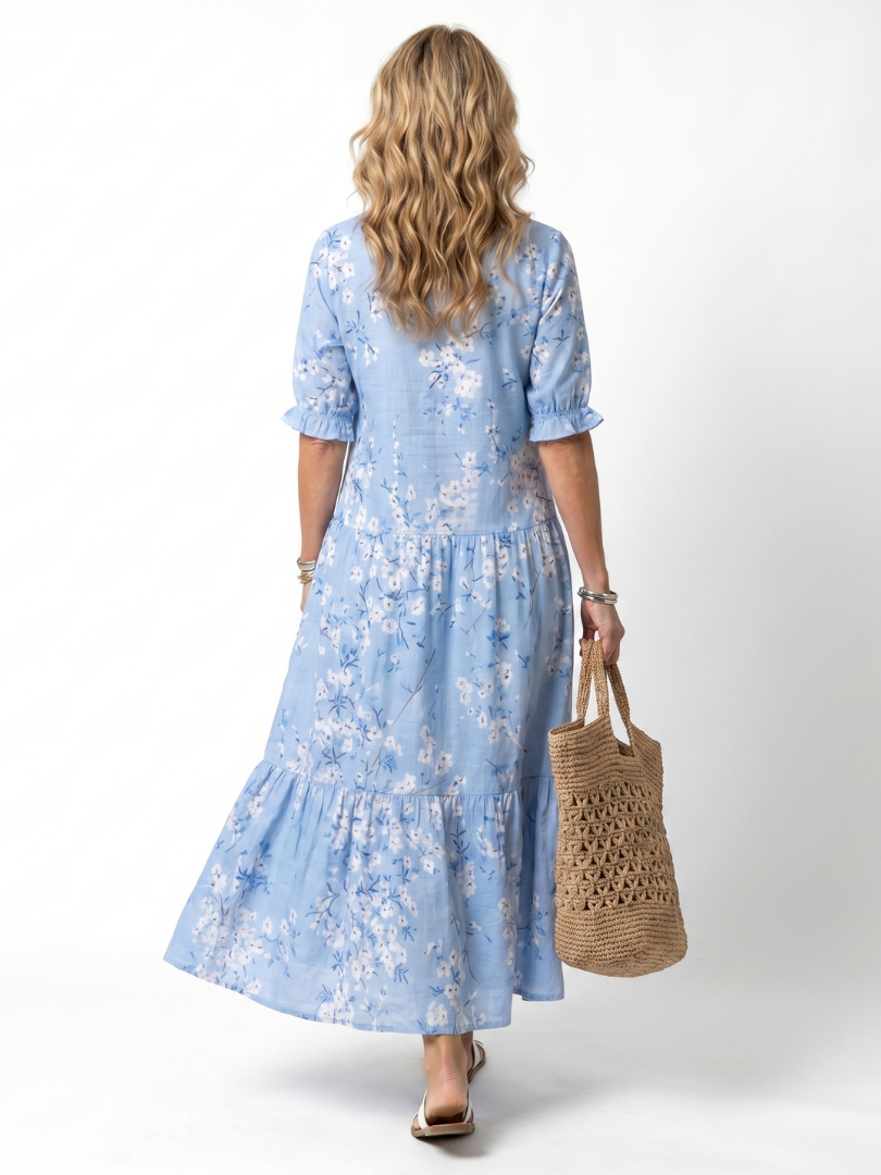 Blue floral midi dress back view with short puff sleeves and tiered skirt