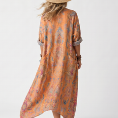 Back view of orange printed midi dress with notch neck and oversized silhouette