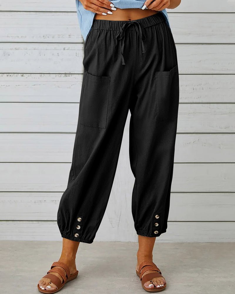 Black high-waist drawstring jogger trousers with side pockets and snap cuffs.
