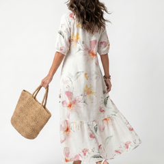 White floral tiered midi dress with V-neck and three-quarter puff sleeves