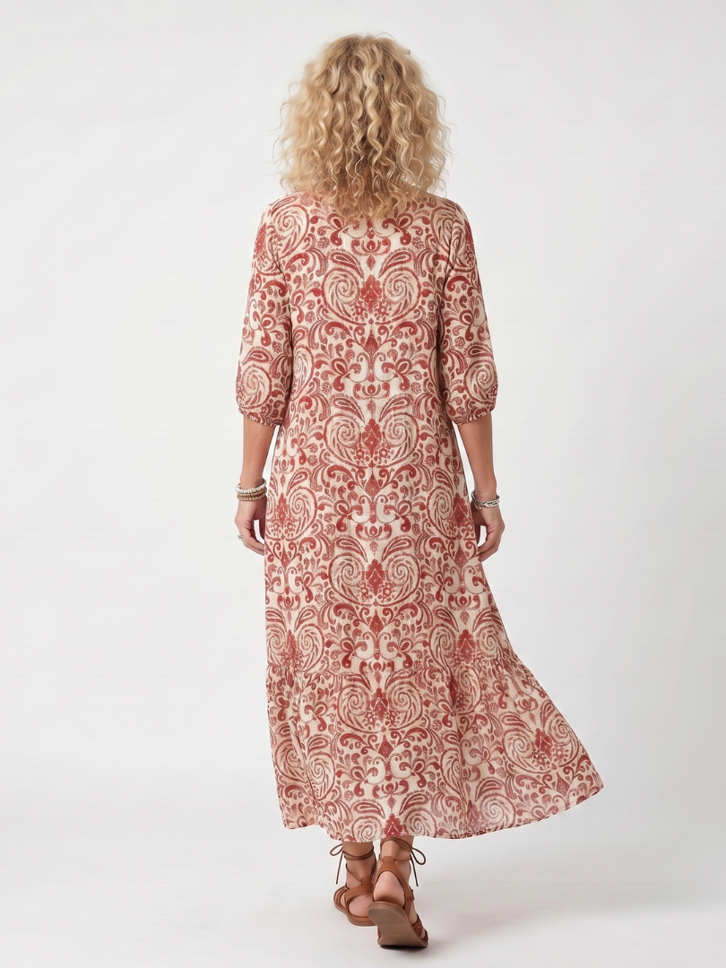 Red ornate print midi dress back view with three-quarter sleeves and flared hem
