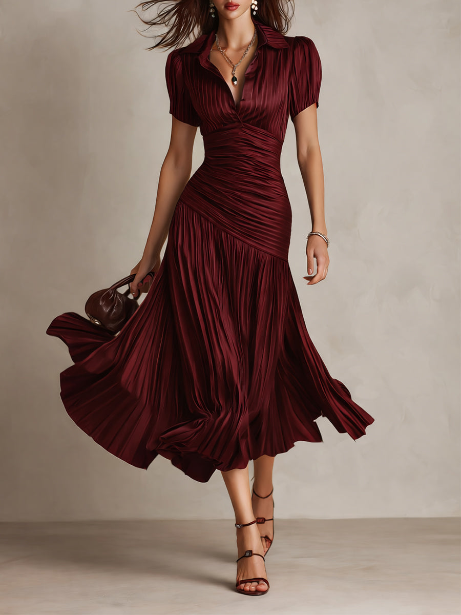 Red striped satin midi dress with V-neck, ruched waist, short sleeves, flowing pleated skirt.