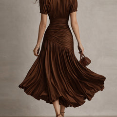 Brown striped satin midi dress from back, short sleeves, ruched waist, flared pleated hem.