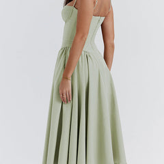 Abito corsetto verde chiaro con spalline sottili e gonna svasata a pieghe