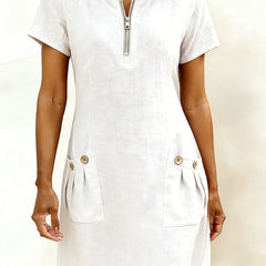 Abito in cotone bianco con zip frontale e tasche laterali con bottoni