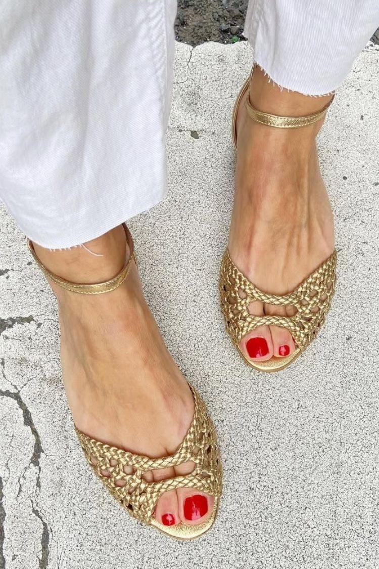 Gold woven open-toe sandals with thin ankle strap and crisscross vamp