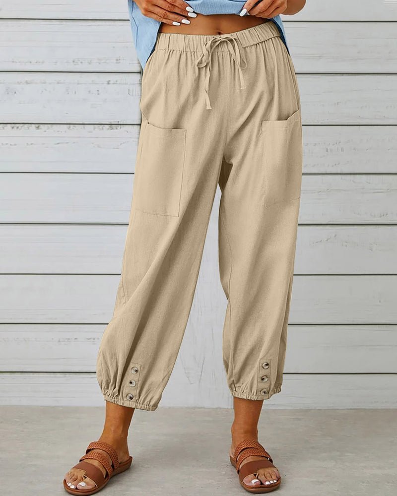 Khaki high-waist drawstring jogger trousers with side pockets and snap cuffs.