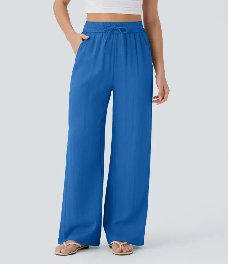 Blue wide-leg trousers with elastic waistband and drawstring ties
