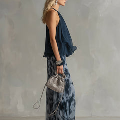 Two-piece halter ruffle top and wide-leg printed pants set, side view with drape