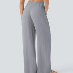 Grey wide-leg trousers with elastic waist and drawstring, full-length wide leg.
