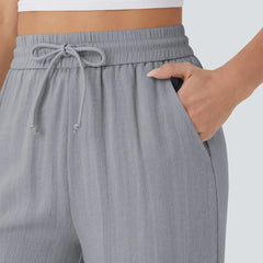 Grey wide-leg trousers: elastic waistband with drawstring bow detail.