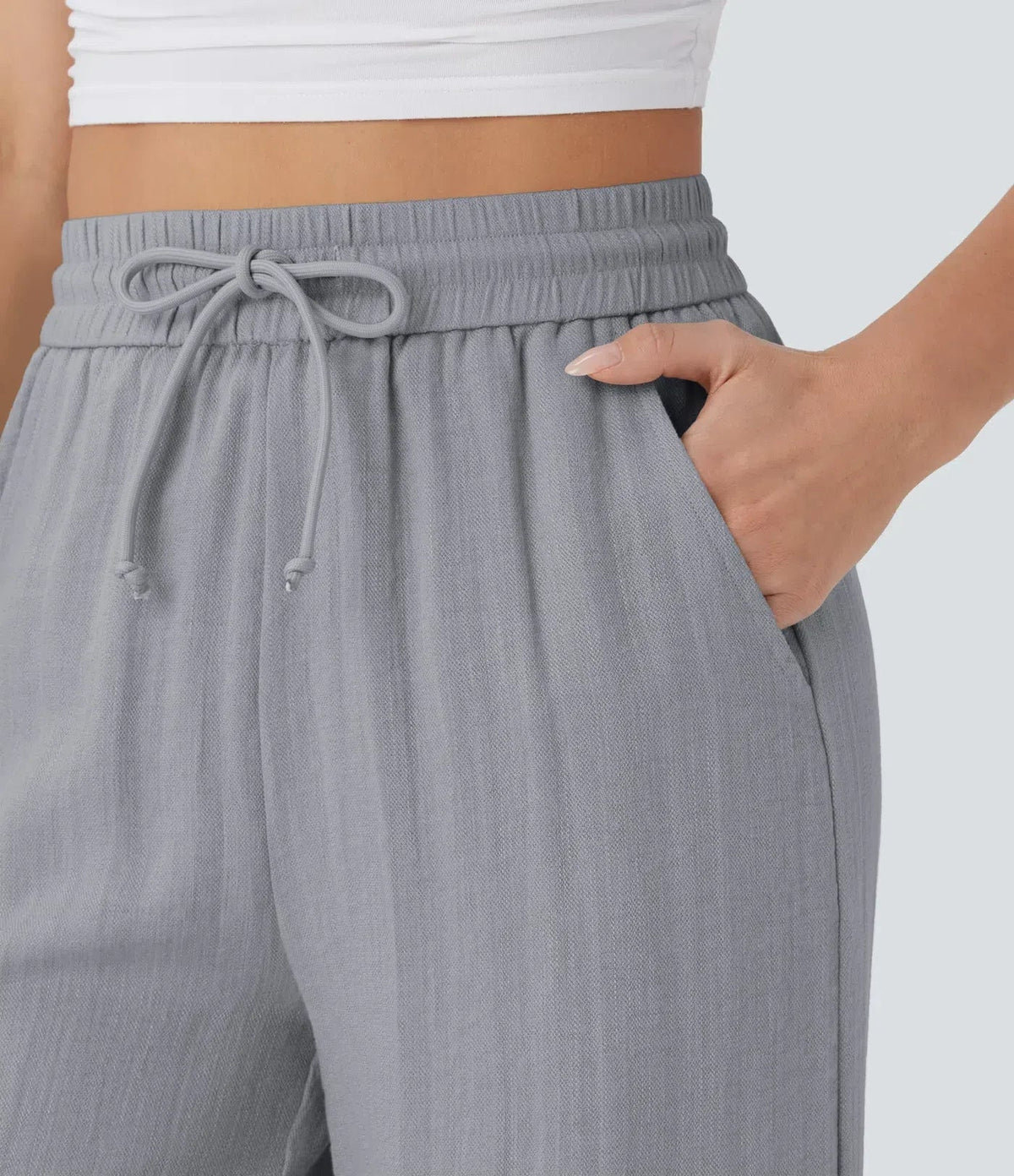 Grey wide-leg trousers: elastic waistband with drawstring bow detail.