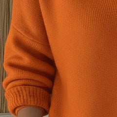 Women’s orange button-collar cardigan sleeve detail with ribbed cuff and knit texture