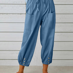 Sky blue high-waist drawstring jogger trousers with side pockets and snap cuffs.