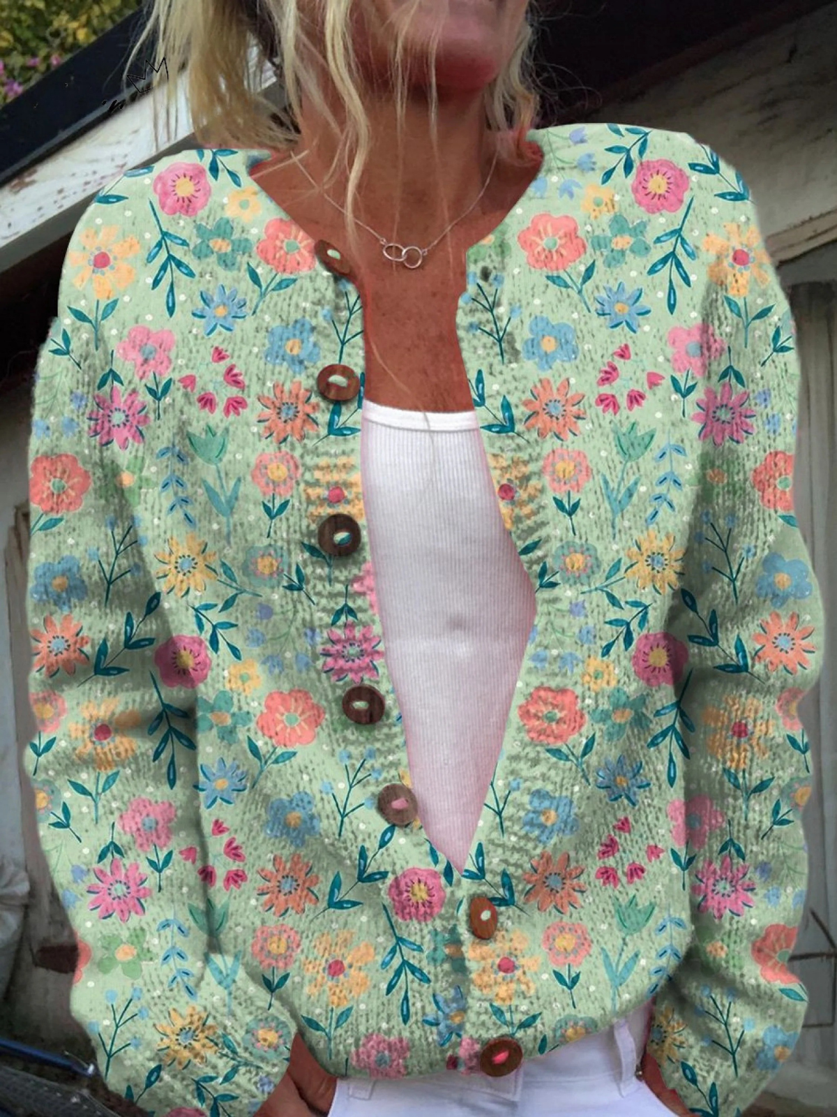 Women's vintage floral cardigan in teal with button-front and brown buttons