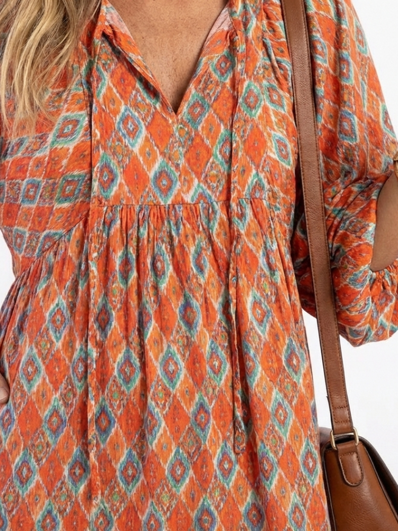 Geometric print V-neck tiered midi dress bodice, orange with blue diamond pattern