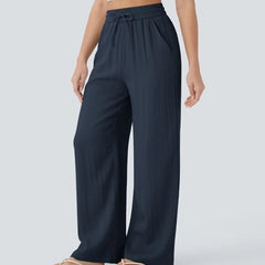 Navy blue wide-leg trousers with elastic waistband and drawstring, full-length.