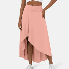 Asymmetric midi skirt in blush pink with high-low hem and draped side panel