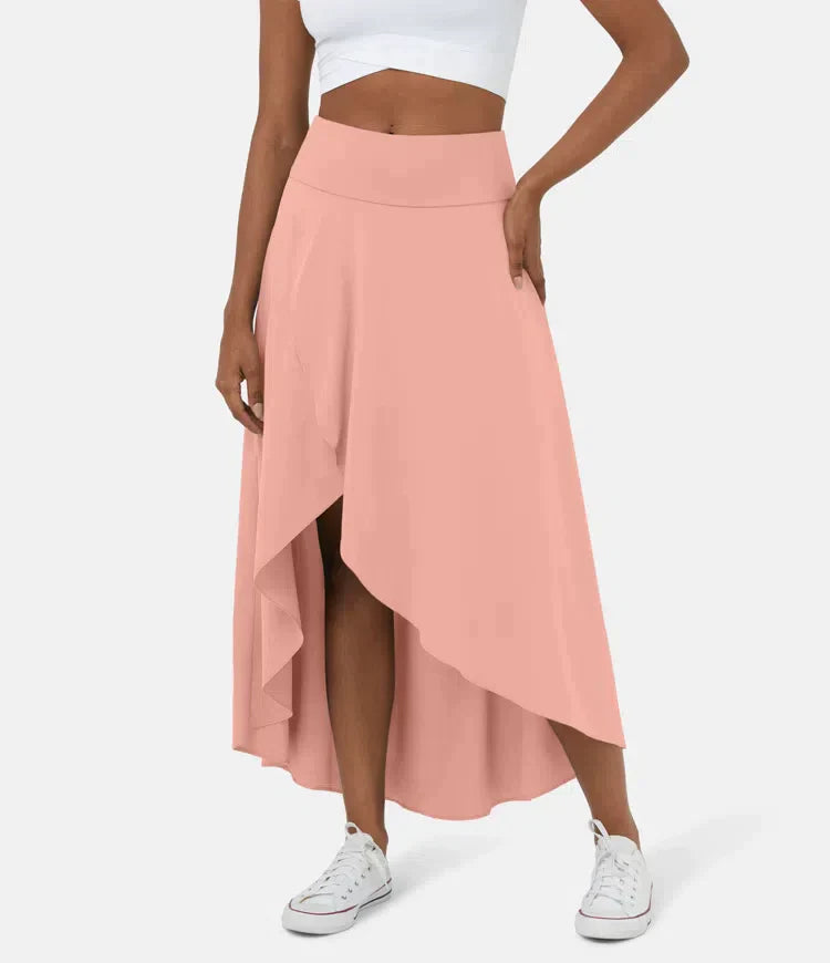 Asymmetric midi skirt in blush pink with high-low hem and draped side panel