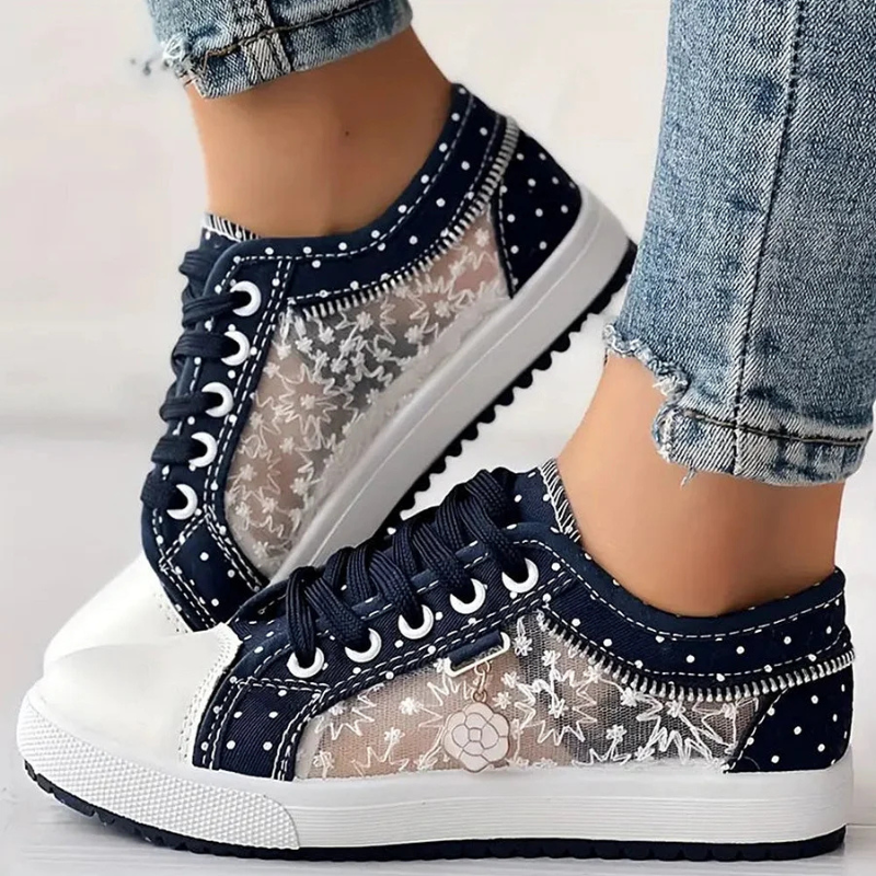 Navy floral lace-up sneakers with white polka dots and stitched border, platform rubber sole.