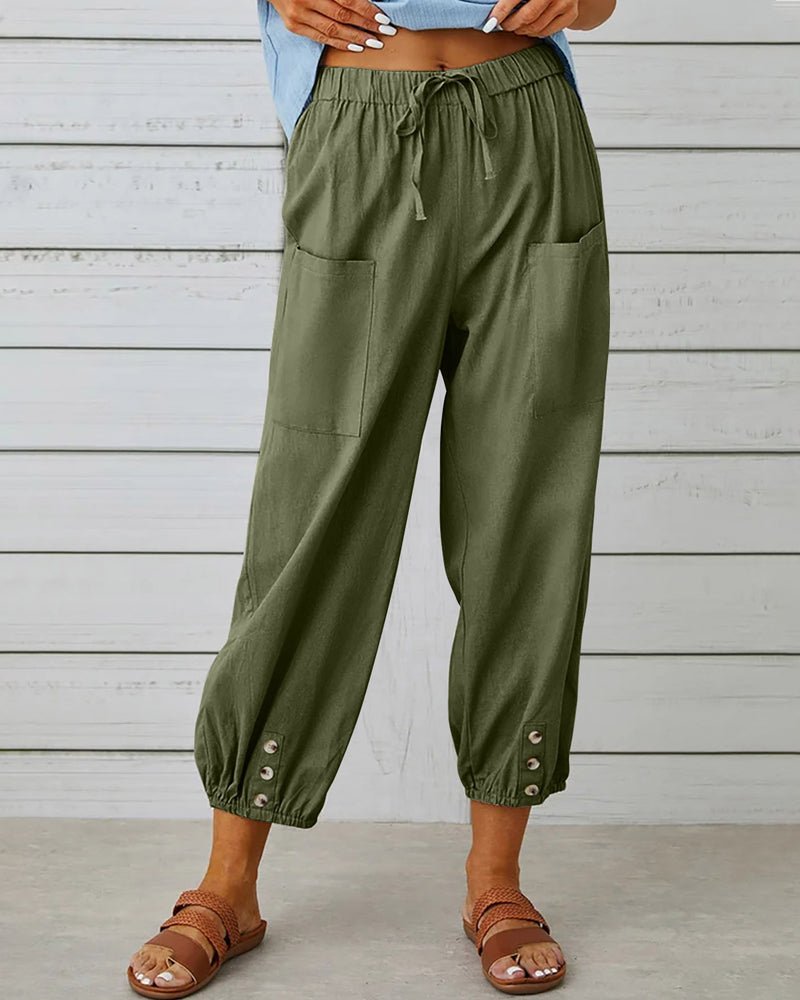 Army green high-waist drawstring jogger trousers with side pockets and snap cuffs.