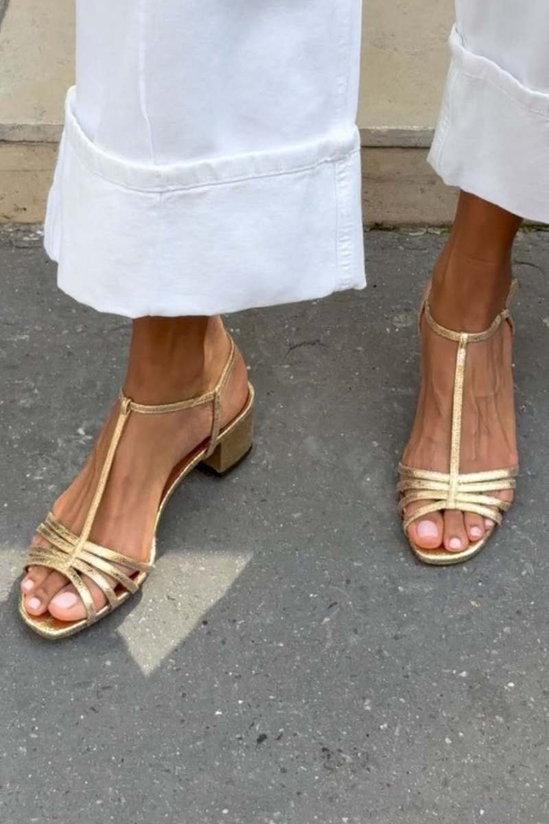 Gold strappy heeled sandals with peep toe and crisscross straps