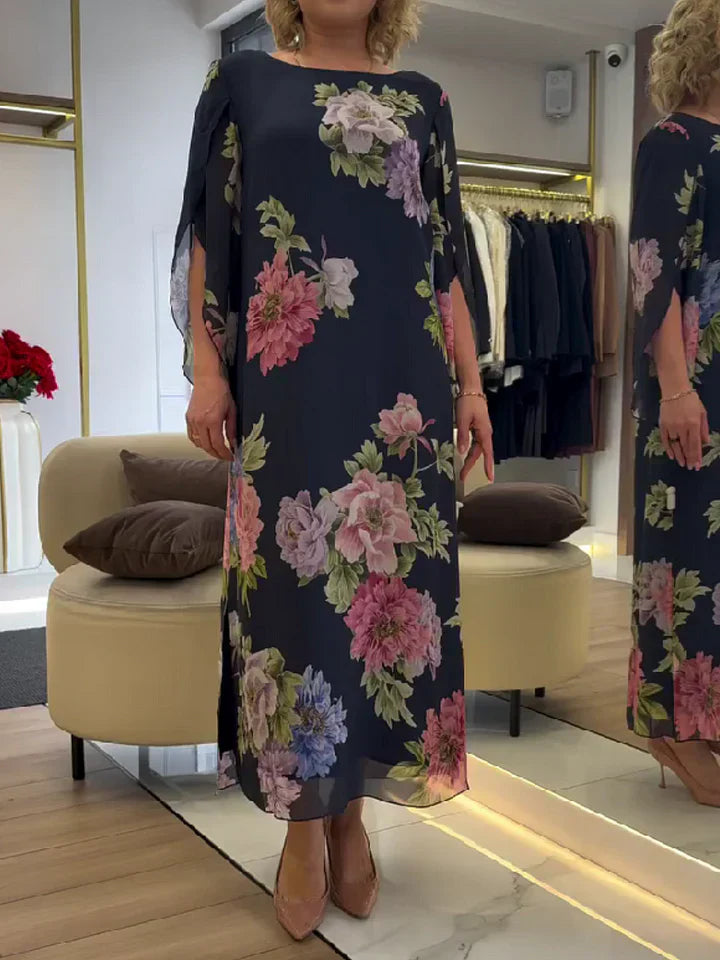 Abito maxi chiffon blu scuro con fiori rosa e azzurri, spalla scesa, linea dritta