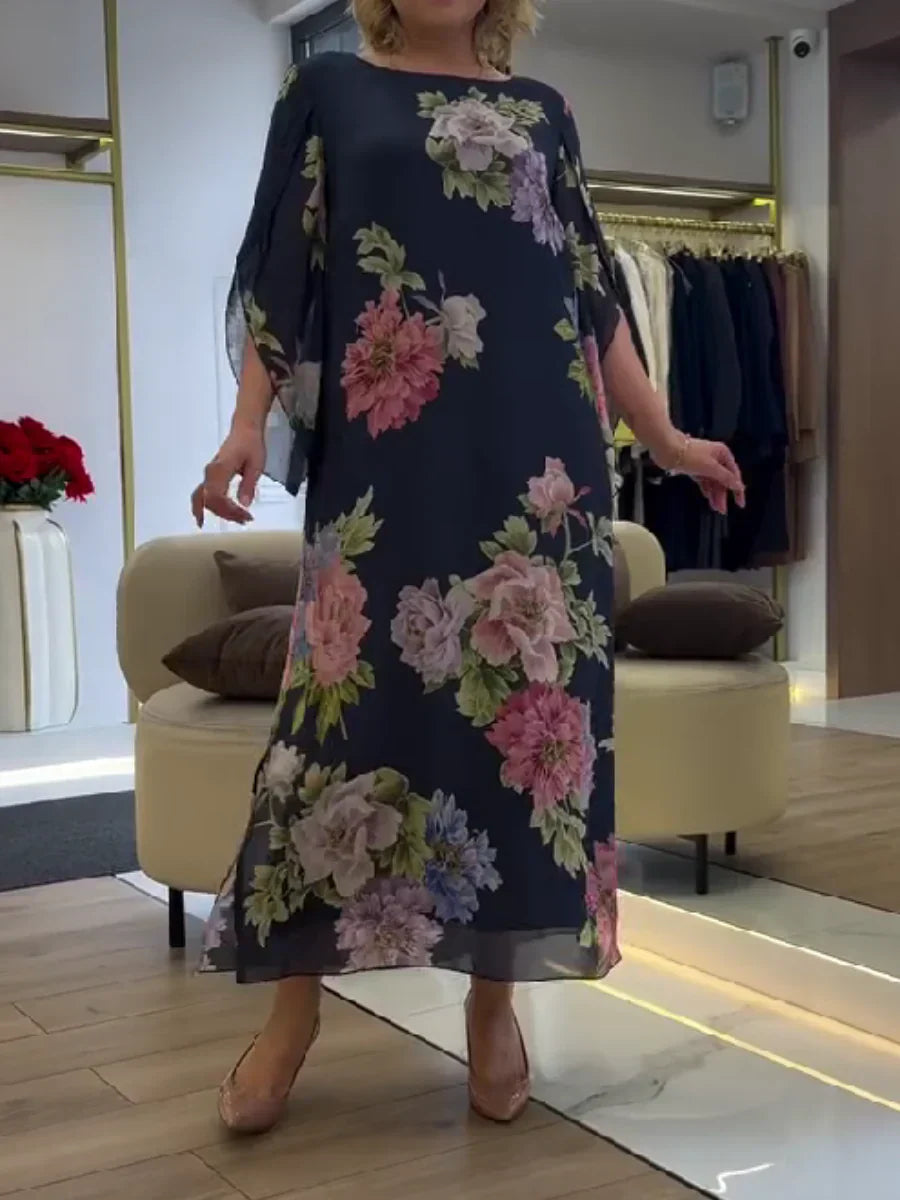 Abito maxi chiffon blu scuro con fiori rosa e verdi, maniche ampie, orlo sotto il ginocchio