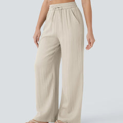 Beige wide-leg trousers with elastic waistband and drawstring ties, side view