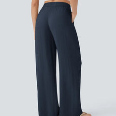 Navy blue wide-leg trousers with elastic waist and drawstring, relaxed fit.