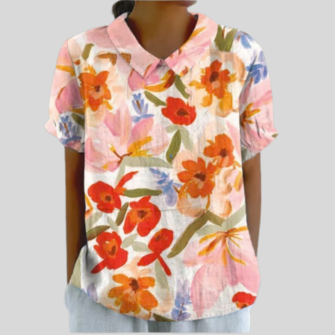 Blusa floreale rosa a maniche corte con scollo a V e colletto, stampa multicolore.