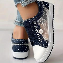 Navy canvas floral sneakers with lace-up closure, white dotted side panel and chunky sole.
