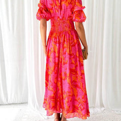Abito maxi sul retro con gonna lunga a fantasia rosa-arancio e maniche a sbuffo