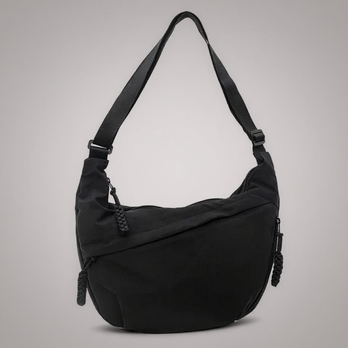 Borsa a tracolla nera in tessuto con tasca laterale con zip e tracolle regolabili