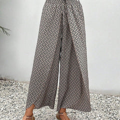 Grey wide-leg trousers with shirred waistband, flowing drape, allover micro pattern.